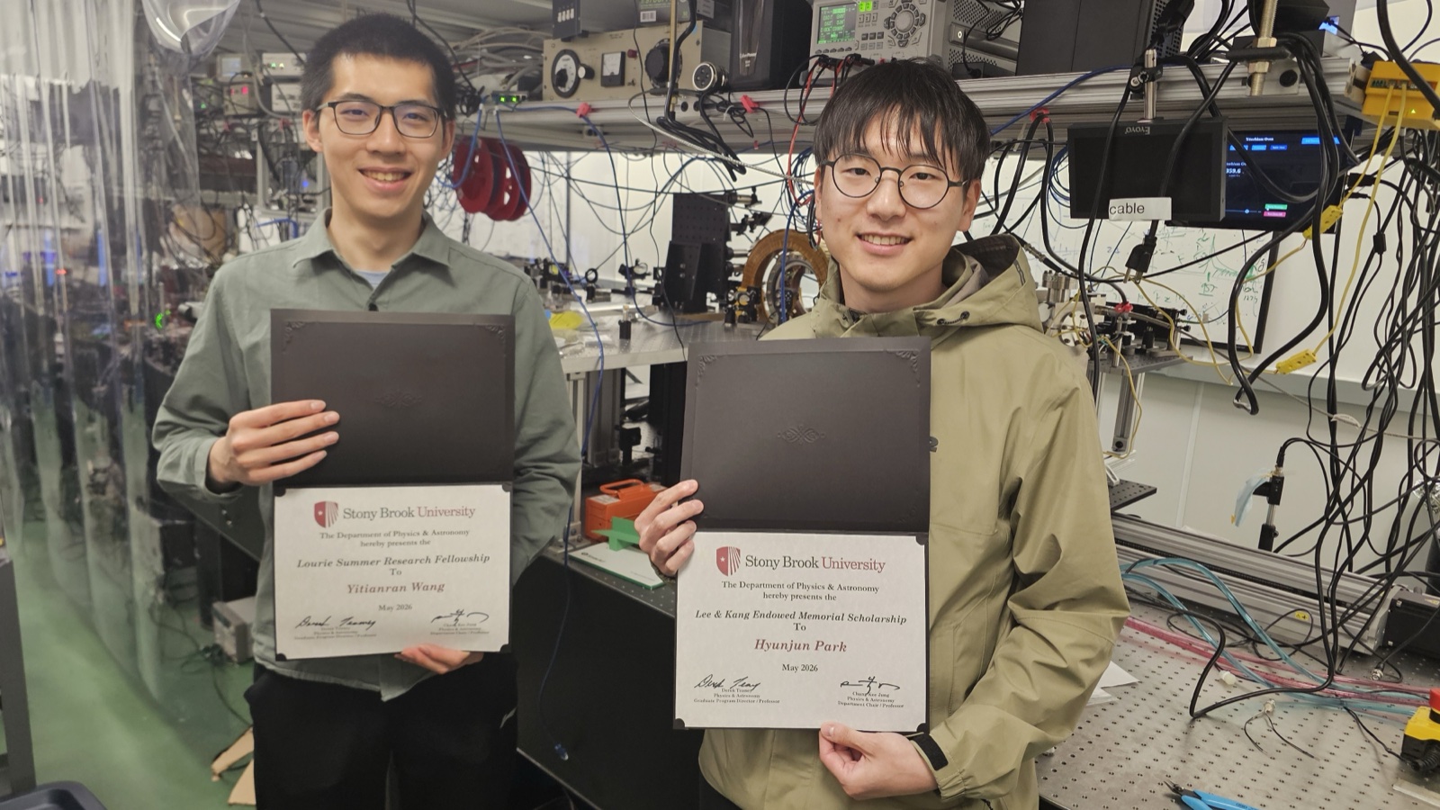 Yitianran Wang and Hyunjun Park holding award certificates.